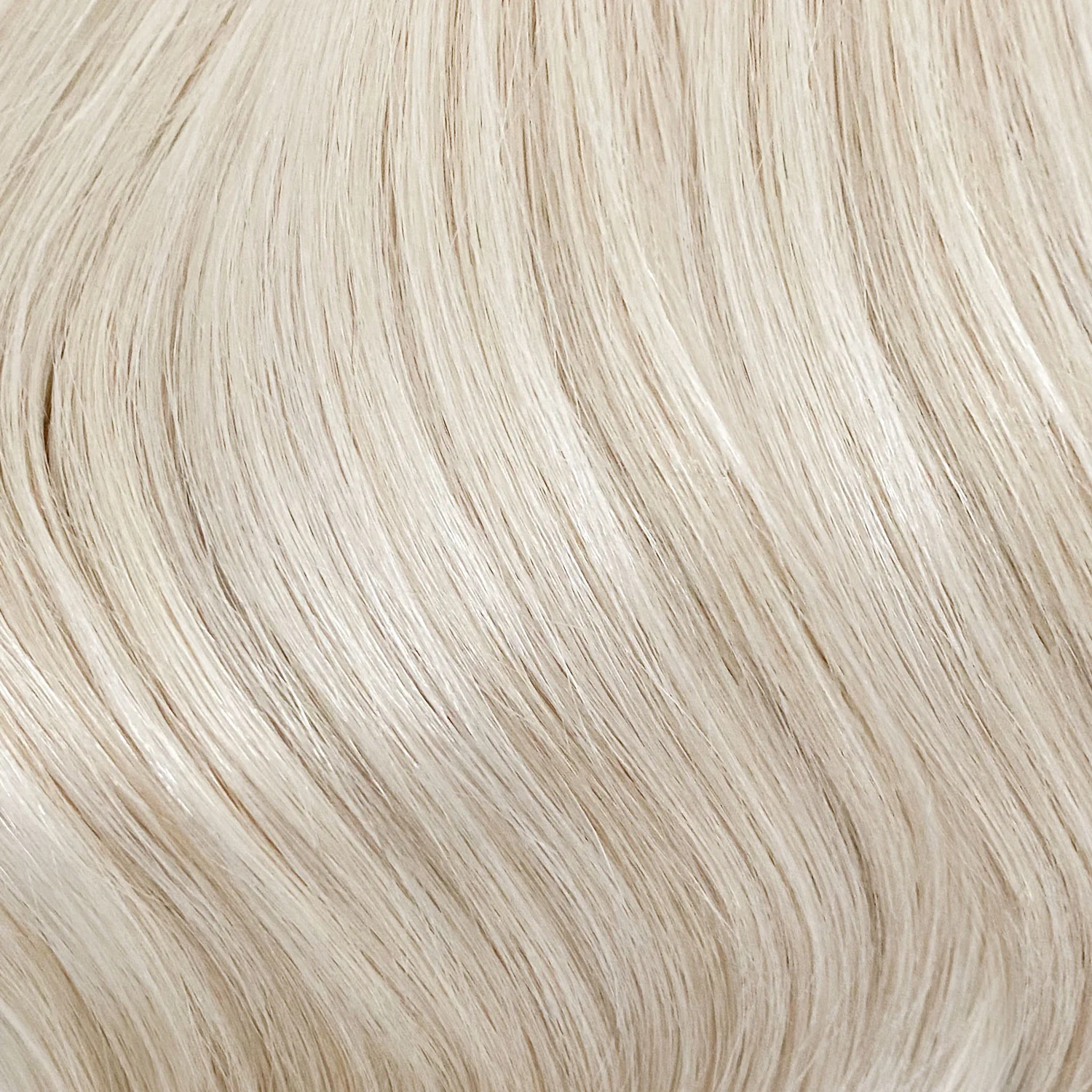 Close-up of smooth, shiny hair strands in light pearl blonde shade for Extra Piece Pearl Blonde 