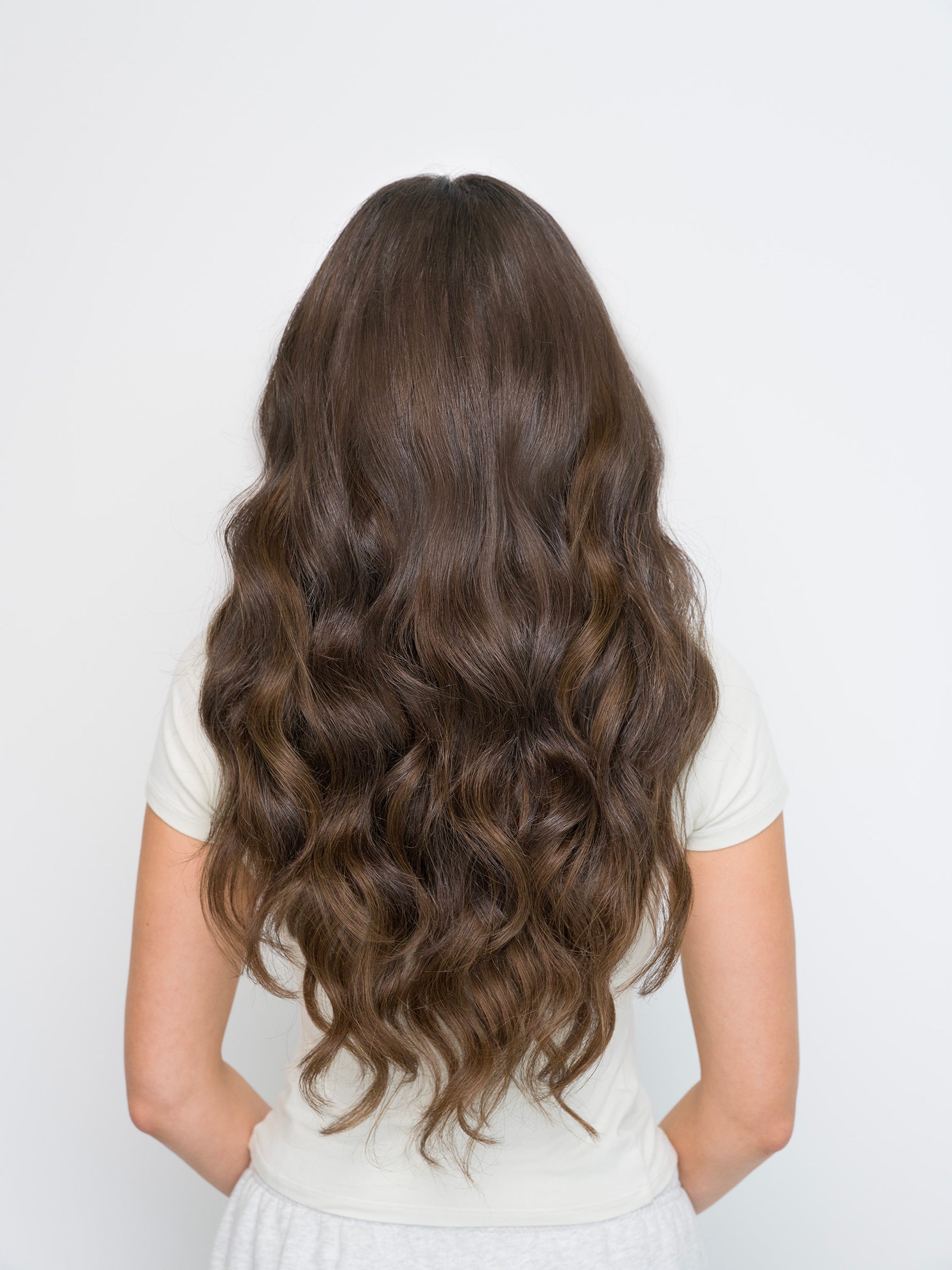 Back view of long wavy brown hair styled with Extra Hair Extension Piece - 