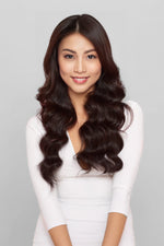 Woman with long wavy deep chocolate hair smiling, showcasing Deep Chocolate 