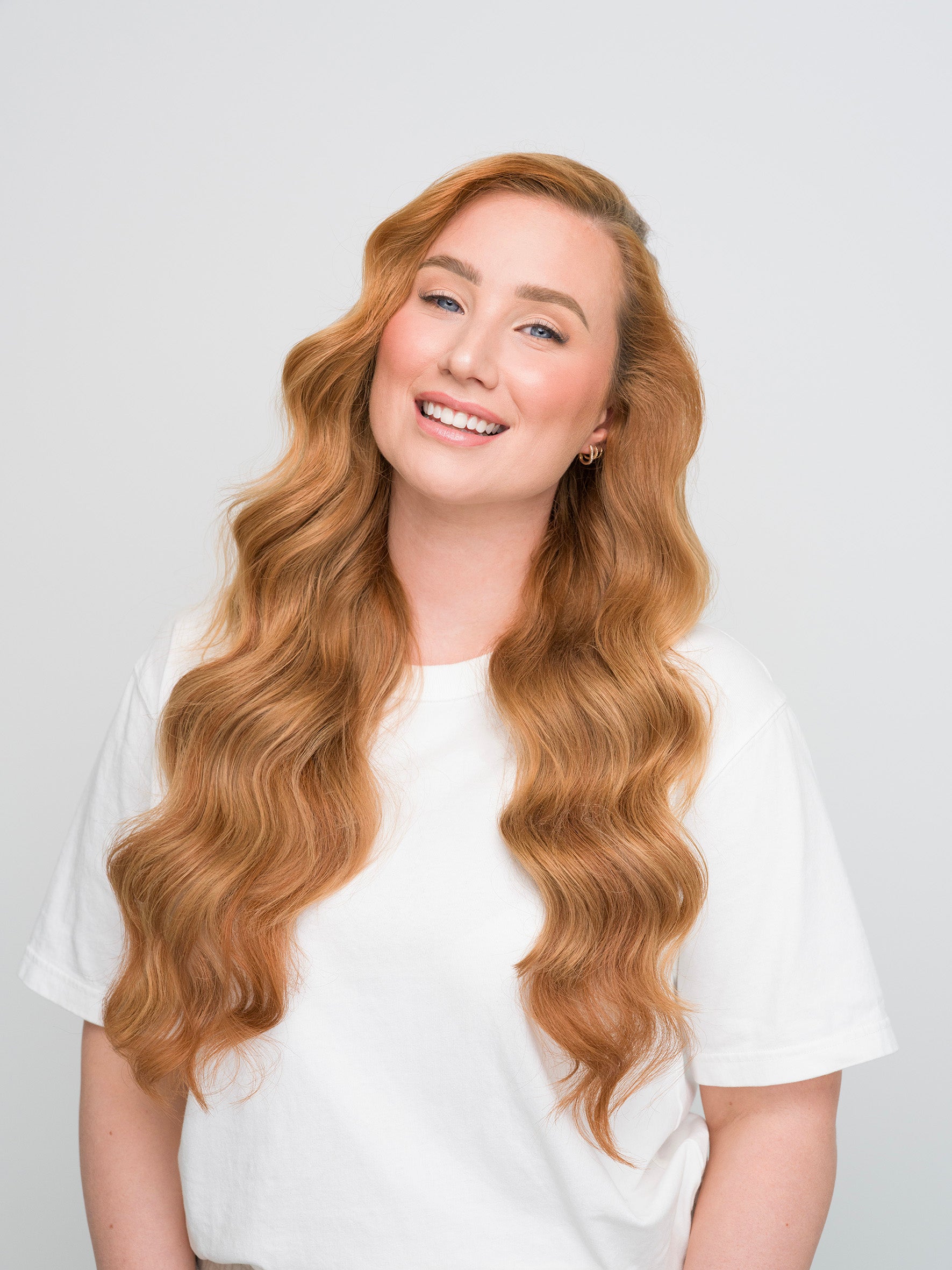 Smiling woman with long, wavy auburn hair showcasing the Extra Hair Extension Piece - Auburn 