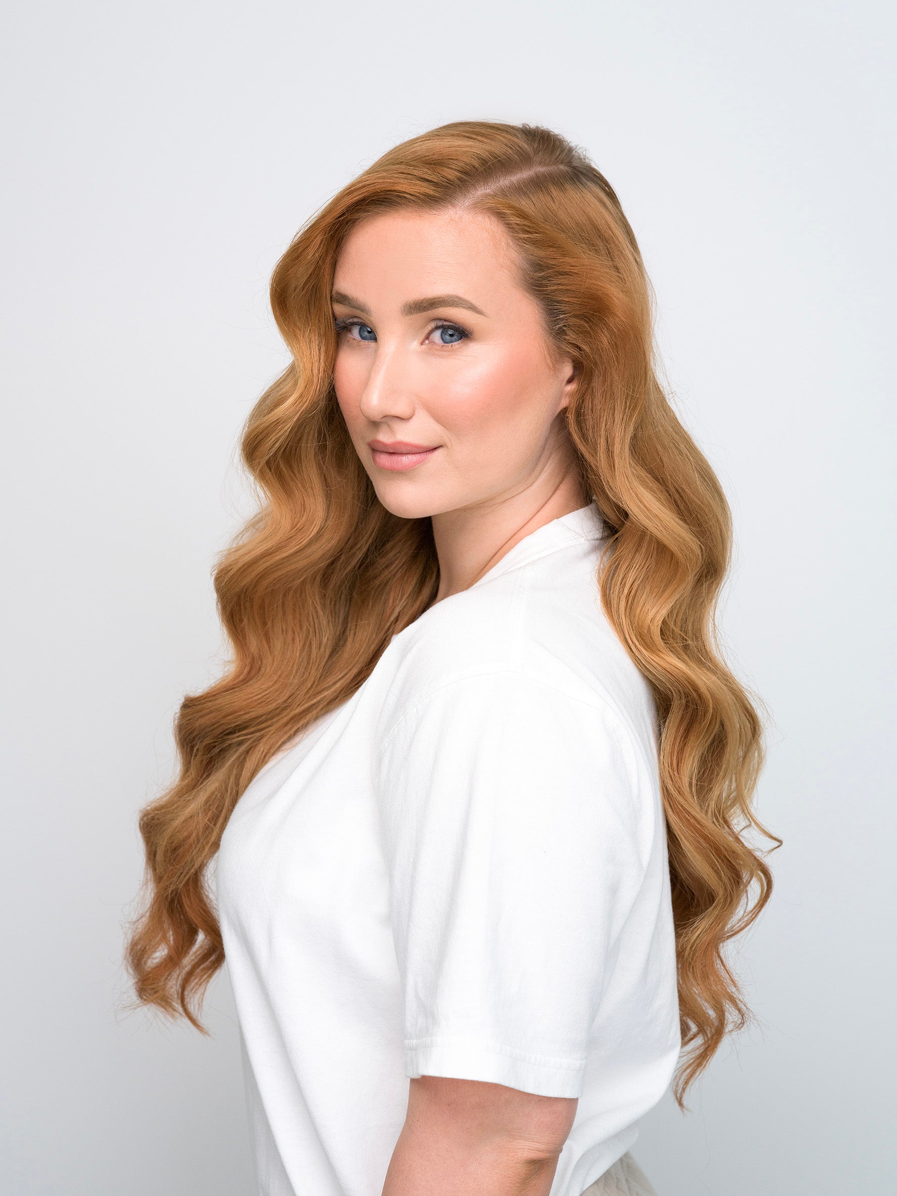 Woman with long wavy auburn hair modeling the Extra Hair Extension Piece - Auburn 