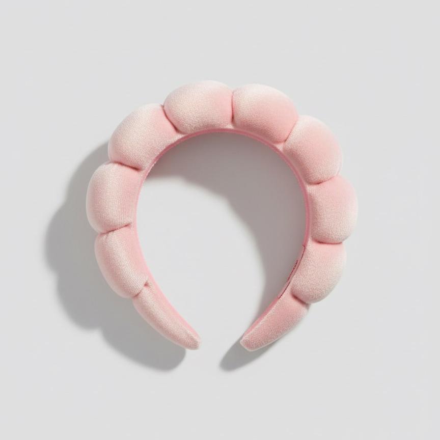 The GRWM Headband in soft pink with padded, textured cushioning for a stylish and comfortable hair accessory.