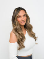 Woman with long wavy hair showcasing the natural blend of Extra Hair Extension Piece - Dark Brown & Blonde Mix 