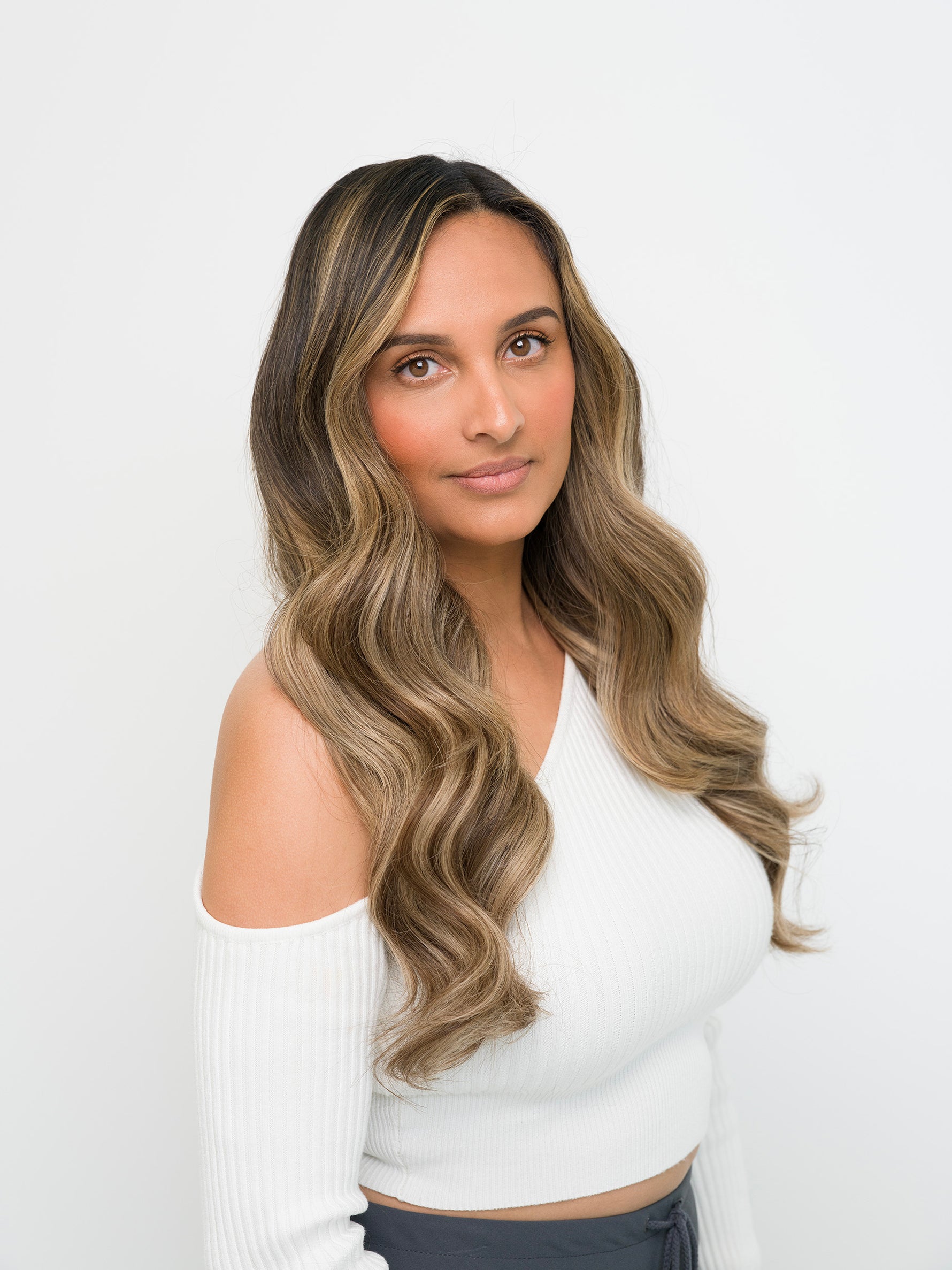 Woman with long wavy hair showcasing the natural blend of Extra Hair Extension Piece - Dark Brown & Blonde Mix 
