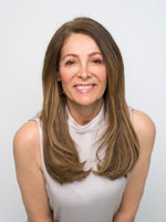 Woman with smooth layered brown hair smiling, showcasing natural look of Extra Hair Extension Piece - 