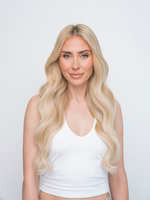 Woman with long, wavy blonde hair wearing the Extra Hair Extension Piece - Bohemian Blonde 
