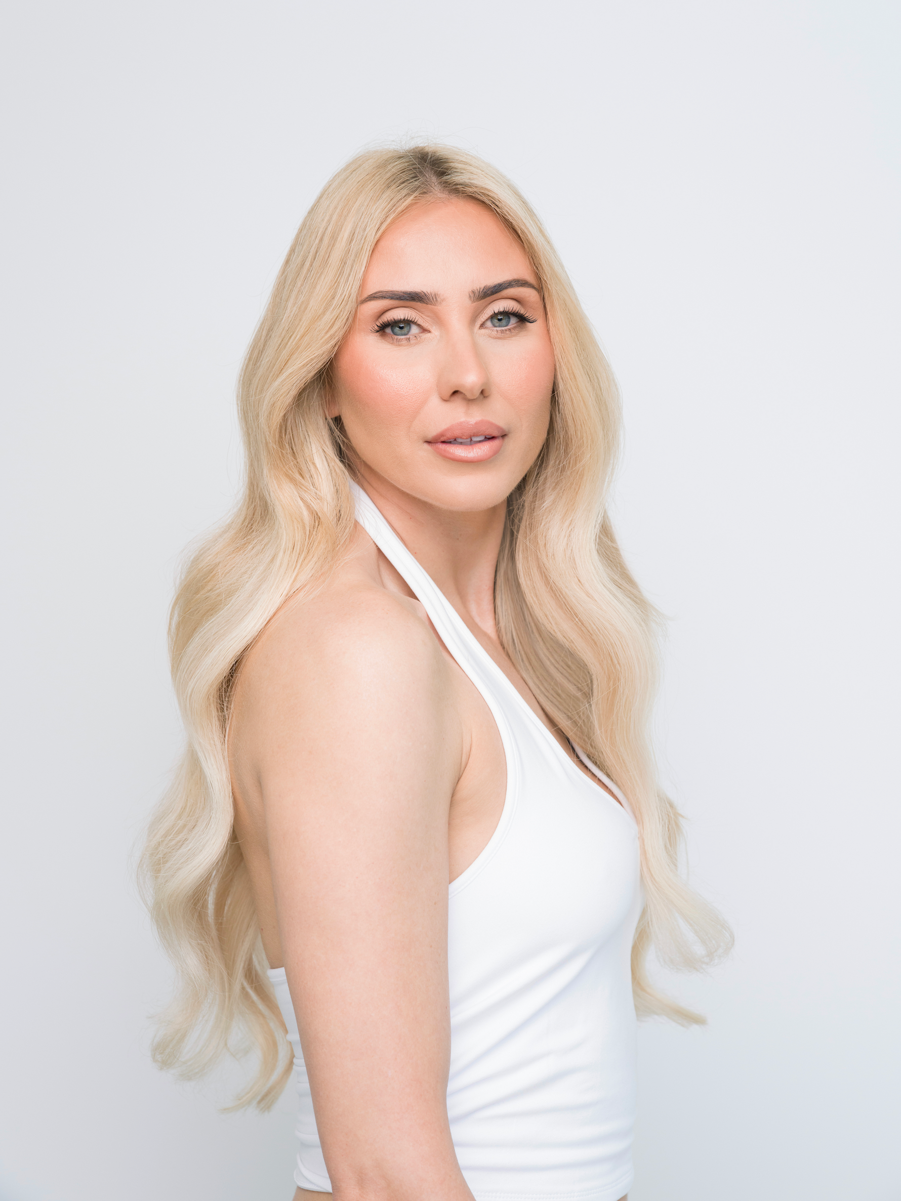 Woman with long wavy blonde hair wearing Extra Hair Extension Piece - Bohemian Blonde 