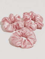 Satin Scrunchie Set featuring three soft, pink, silky hair ties perfect for gentle styling and an elegant look
